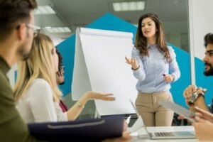 Confident young team leader giving a presentation to a group of